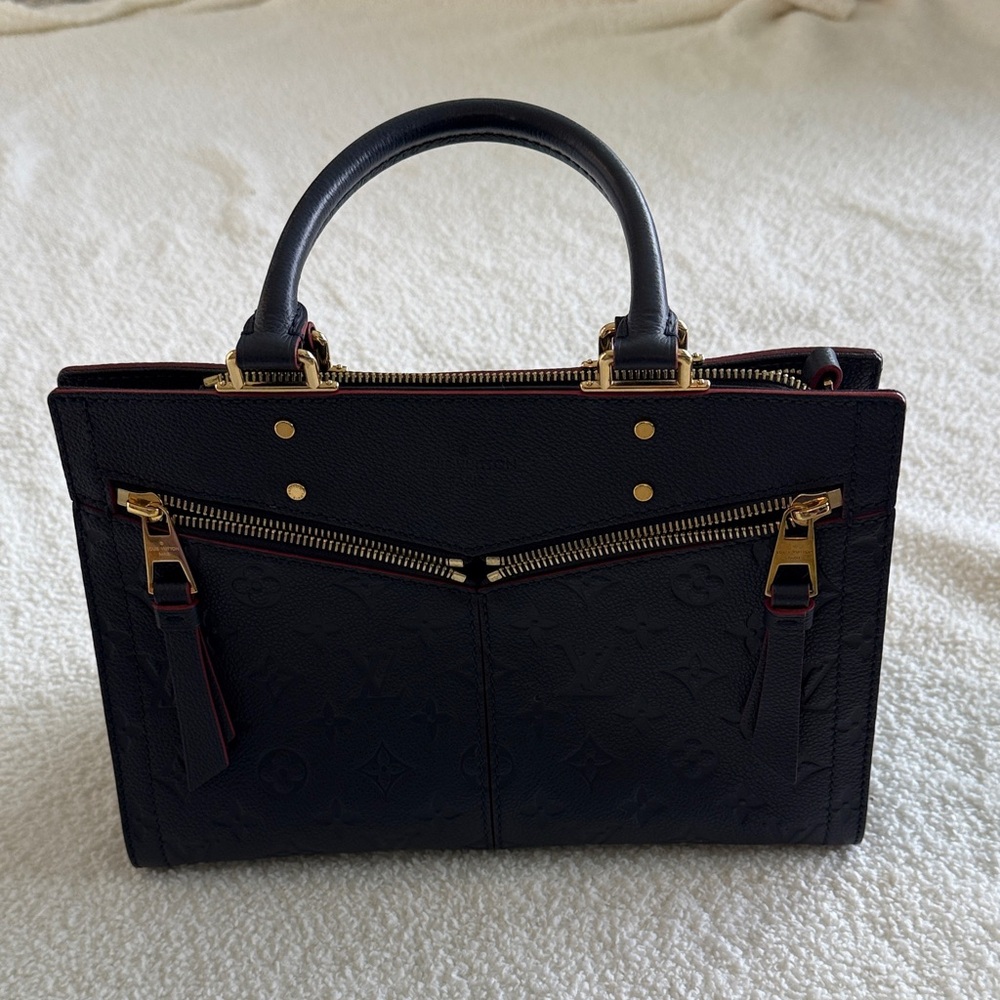Louis Vuitton navy blue and Gold Satchel with red accent trim.